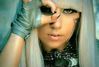 Zpěvačka Lady Gaga dívající se jedním okem přes prsty