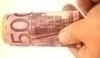 Fotografie bankovky Euro v ruce