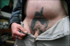 Muž s tetováním v podbřišku