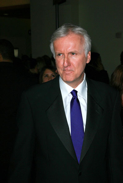 James Cameron v obleku s modrou kravatou