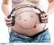 Těhotná žena s pokresleným břichem a se sluchátky na břiše